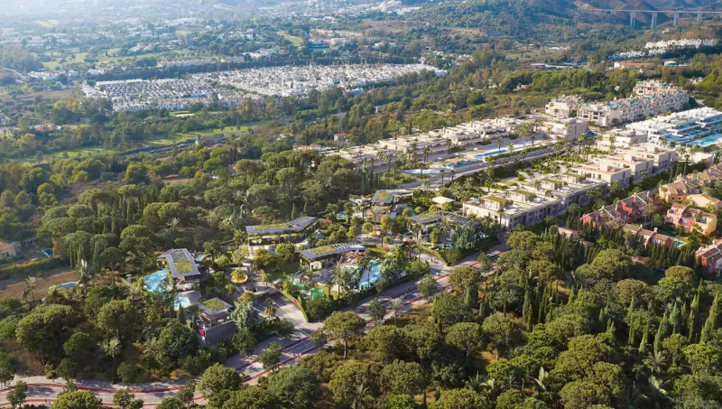 Aerial view of Karl Lagerfeld Villas Marbella luxury residential complex in Spain, with villas, pools, and lush green surroundings.
