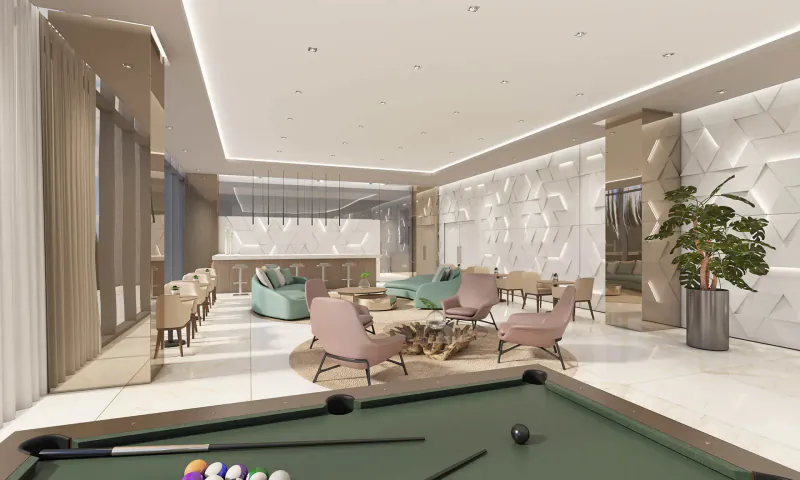 Modern luxury lounge in Oasis Hallandale with teal sofas, pink chairs, pool table with balls, and large plants.