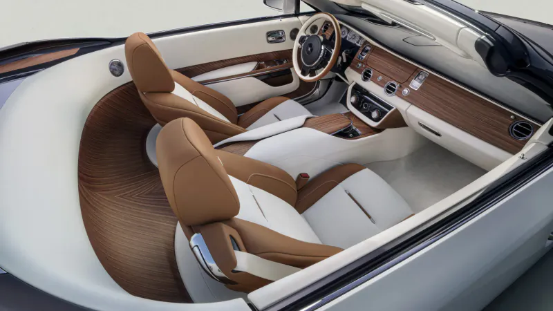 Rolls-Royce Arcadia Droptail convertible interior with white leather seats, wood trim, and open top