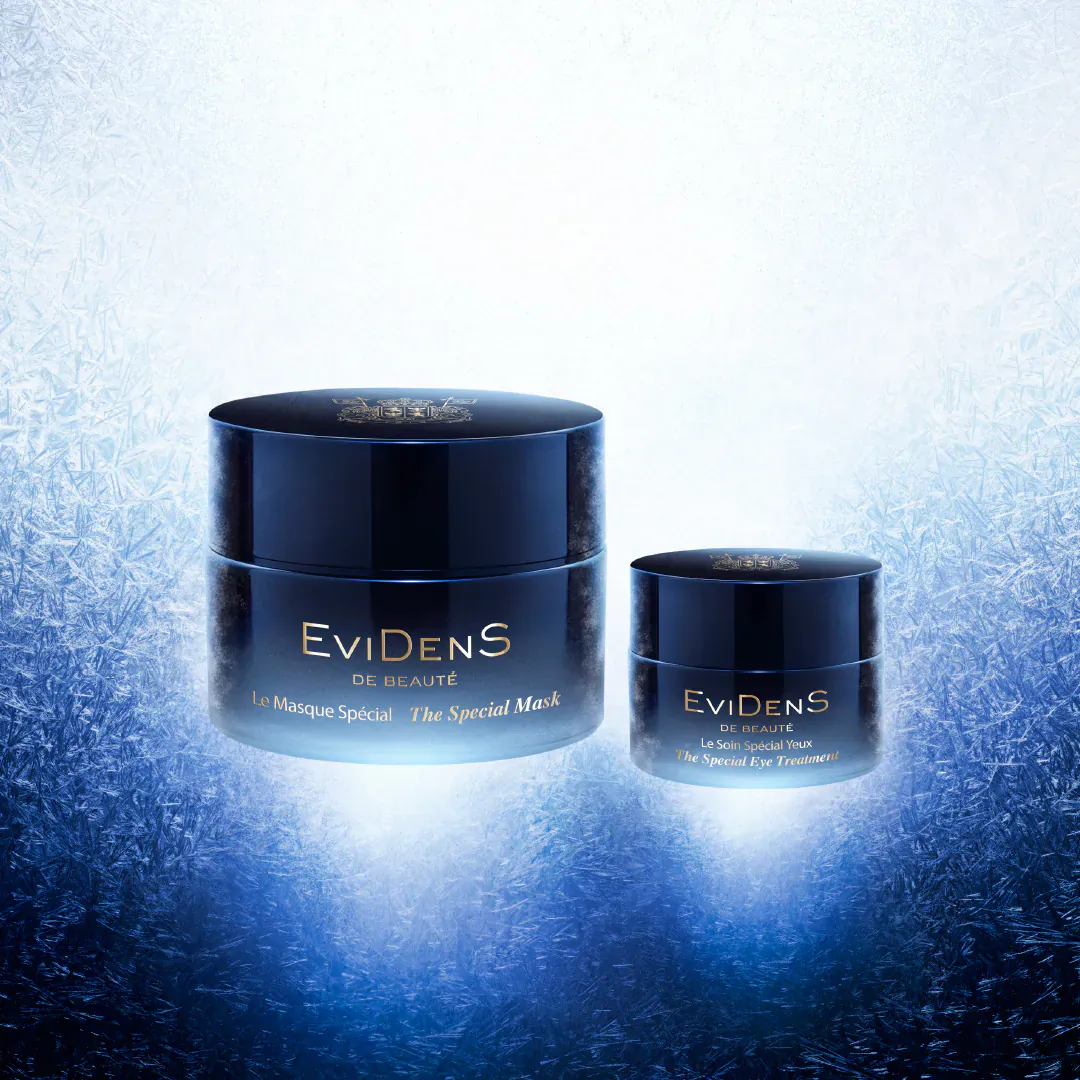Two blue jars of EviDenS de Beauté Le Masque Spécial The Special Mask on glowing blue background.