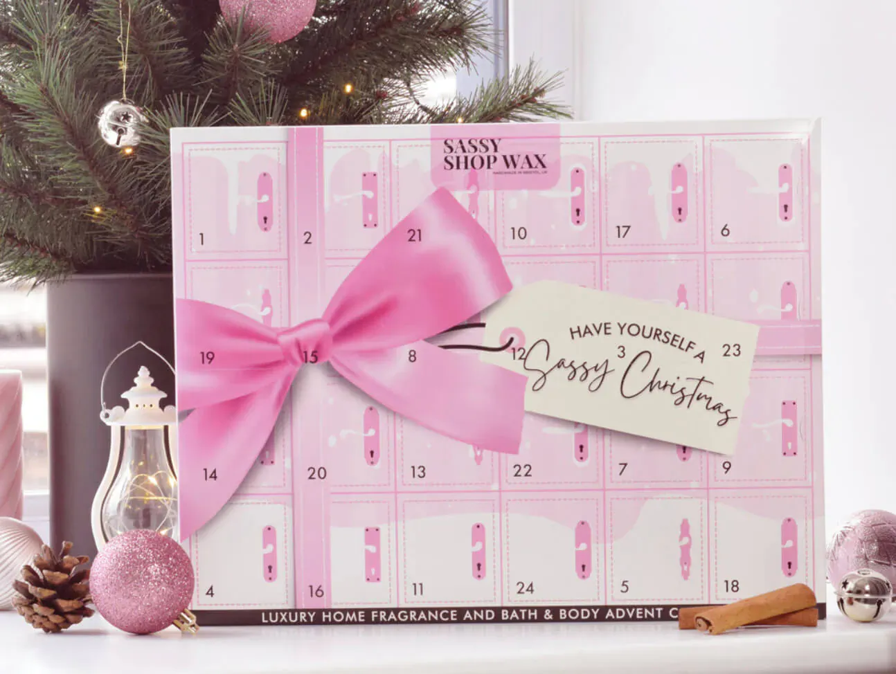 Sassy Shop Wax Sassy Christmas 23 luxury advent calendar with pink bow, numbered doors, pink tree, ornaments.