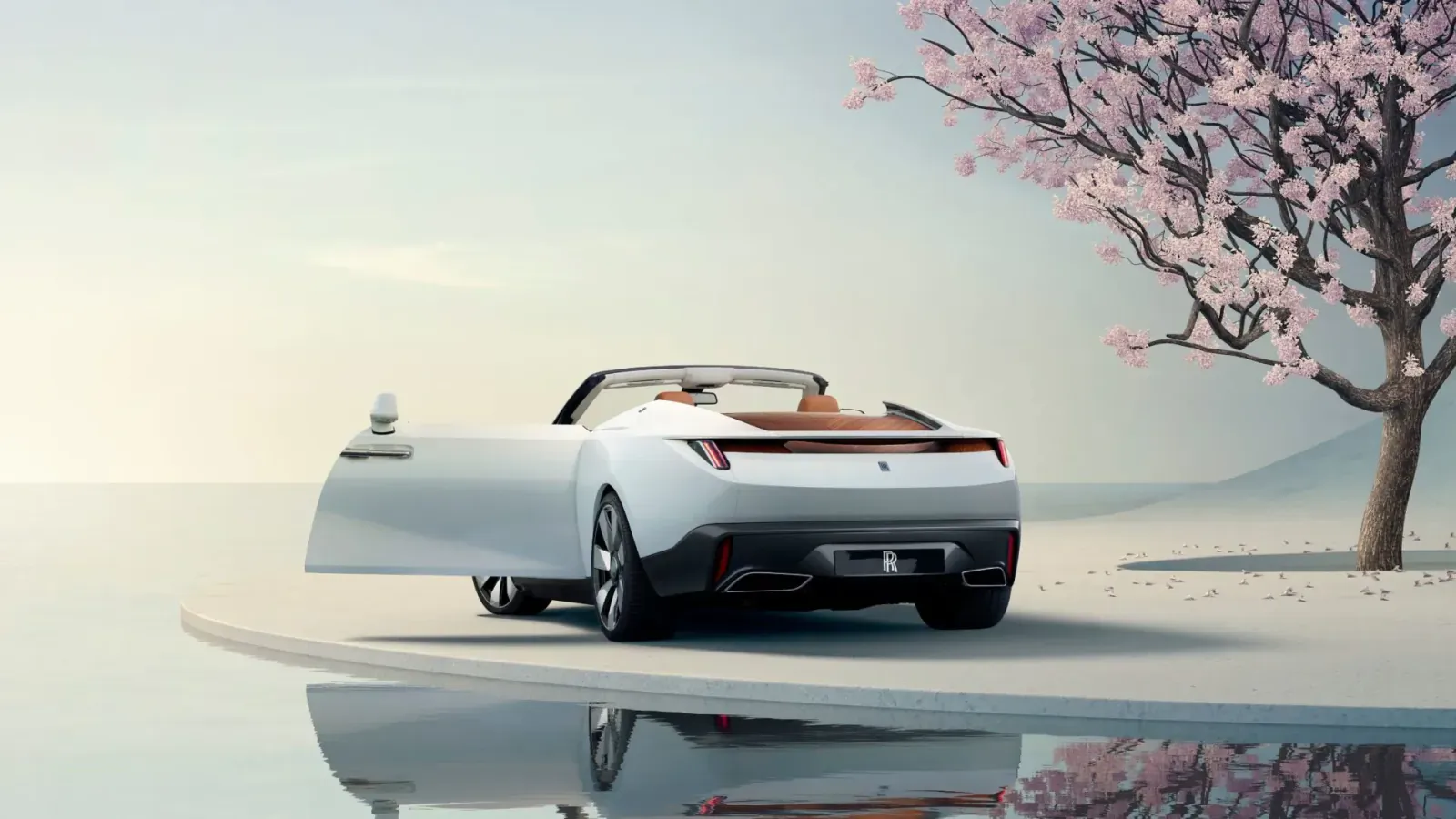 Rear view of white Rolls-Royce Arcadia Droptail convertible with open door, beside pink cherry blossoms and water reflection.