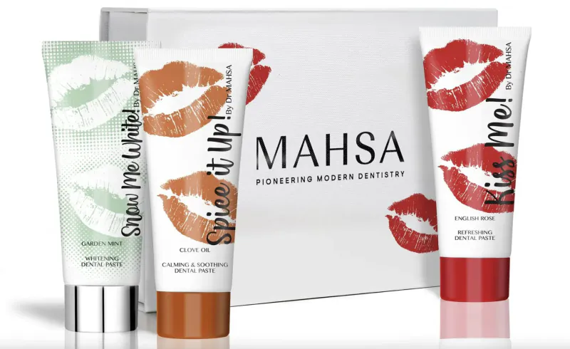 Mahssa Pioneering Modern Dentistry Valentine's lip balms: Spice Me Up (green), Kiss Me (red), white gift box.