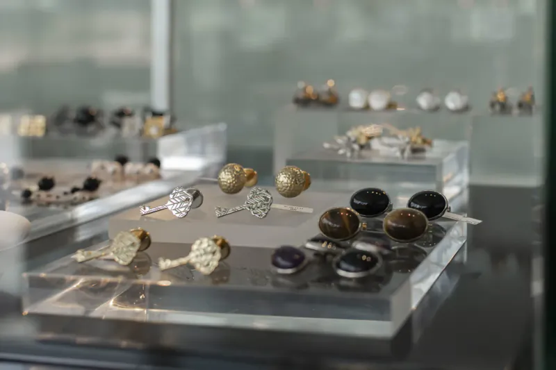 Display case of men's cufflinks in gold, silver, onyx, and tiger's eye at Huwa's Cairo flagship store