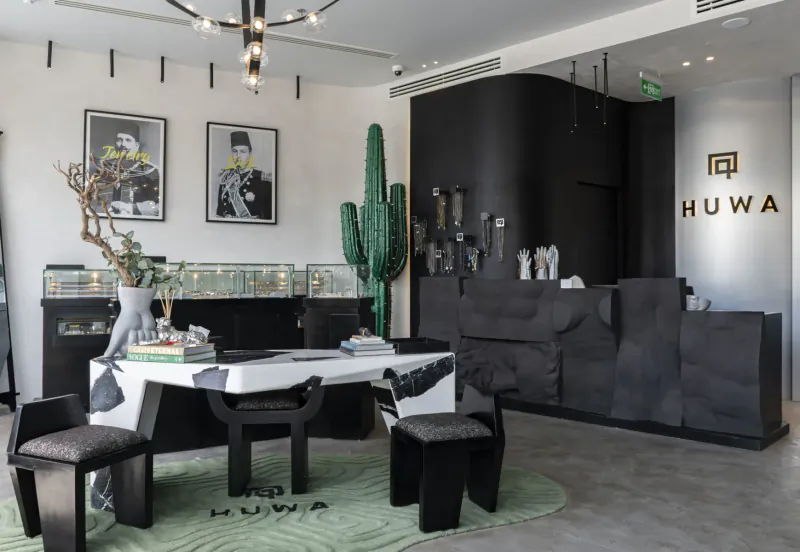 Huwa men's jewellery flagship store in Cairo: modern reception with cacti, black decor, white desk, and 'HUWAWA' signage