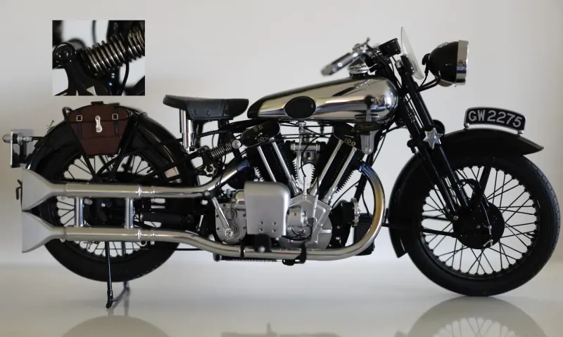 Vintage silver Brough Superior motorcycle on stand, UK plate CR 9226, leather saddlebag, inset suspension detail