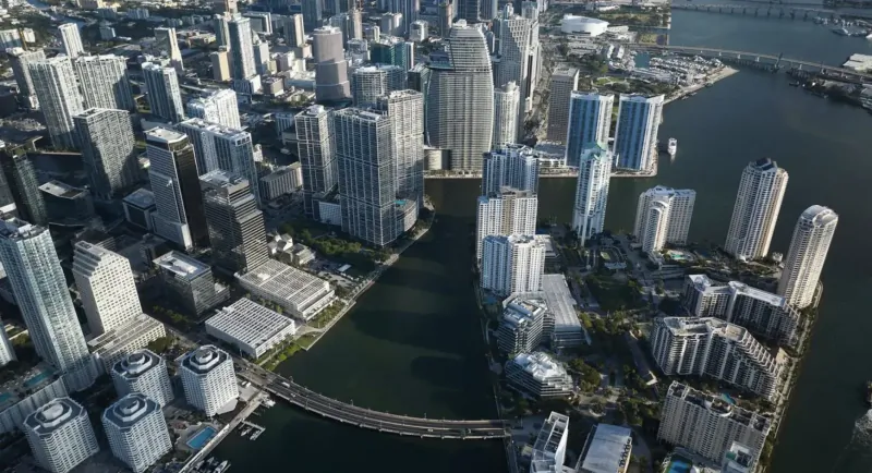 Aerial view of Aston Martin Residences Miami: modern skyscrapers and luxury high-rises along the river and bay.