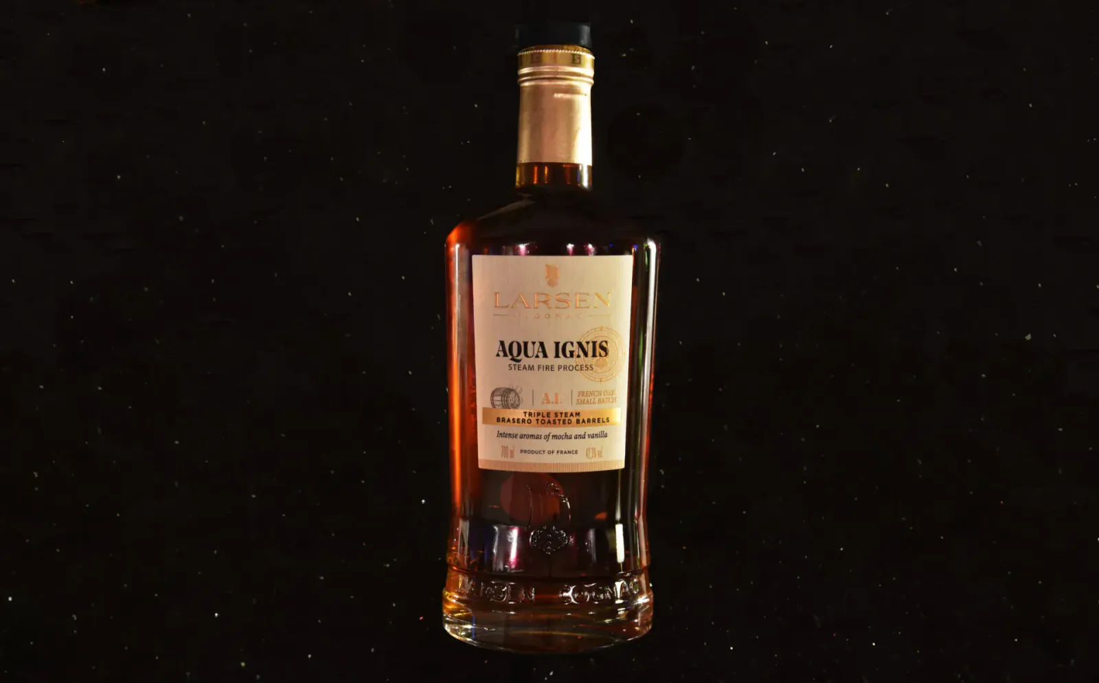 Aqua Regis amber liquor bottle with gold cap on black background, labeled 'Aqua Regis'.