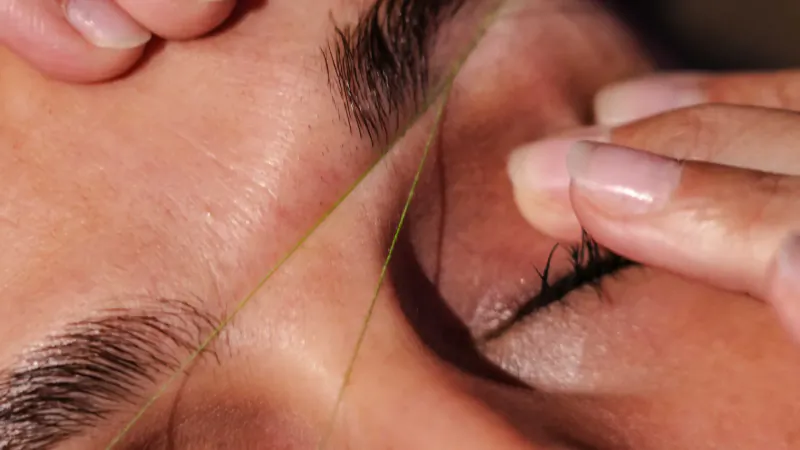 Close-up of threading eyebrows at Urban Retreat London City spa