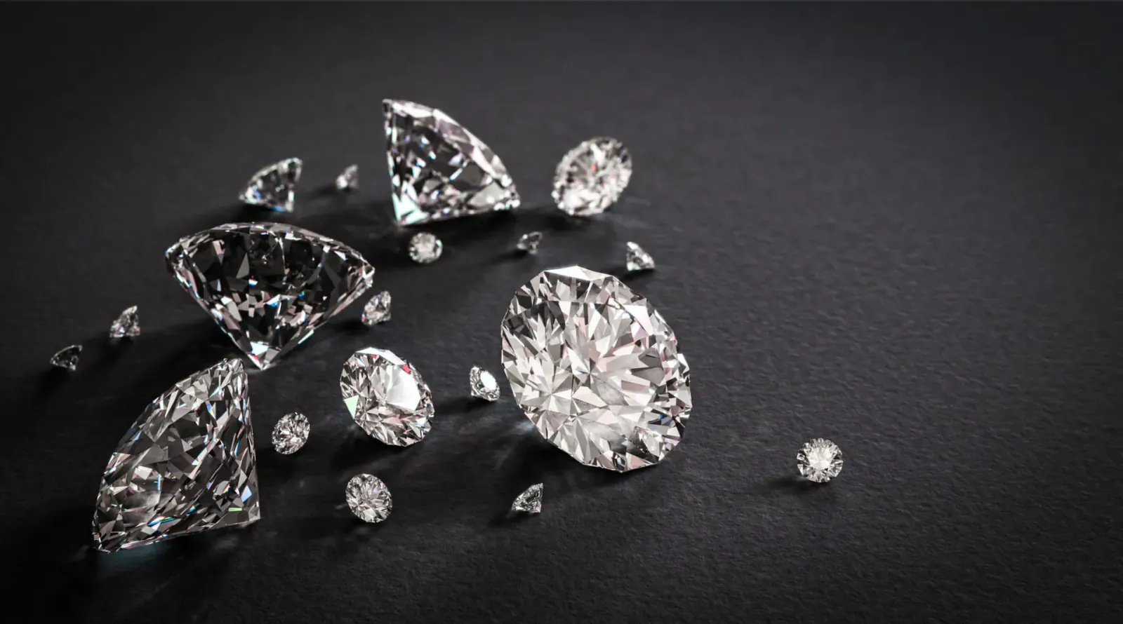 Scatter of sparkling cut diamonds on black background, evoking modern jewelry elegance