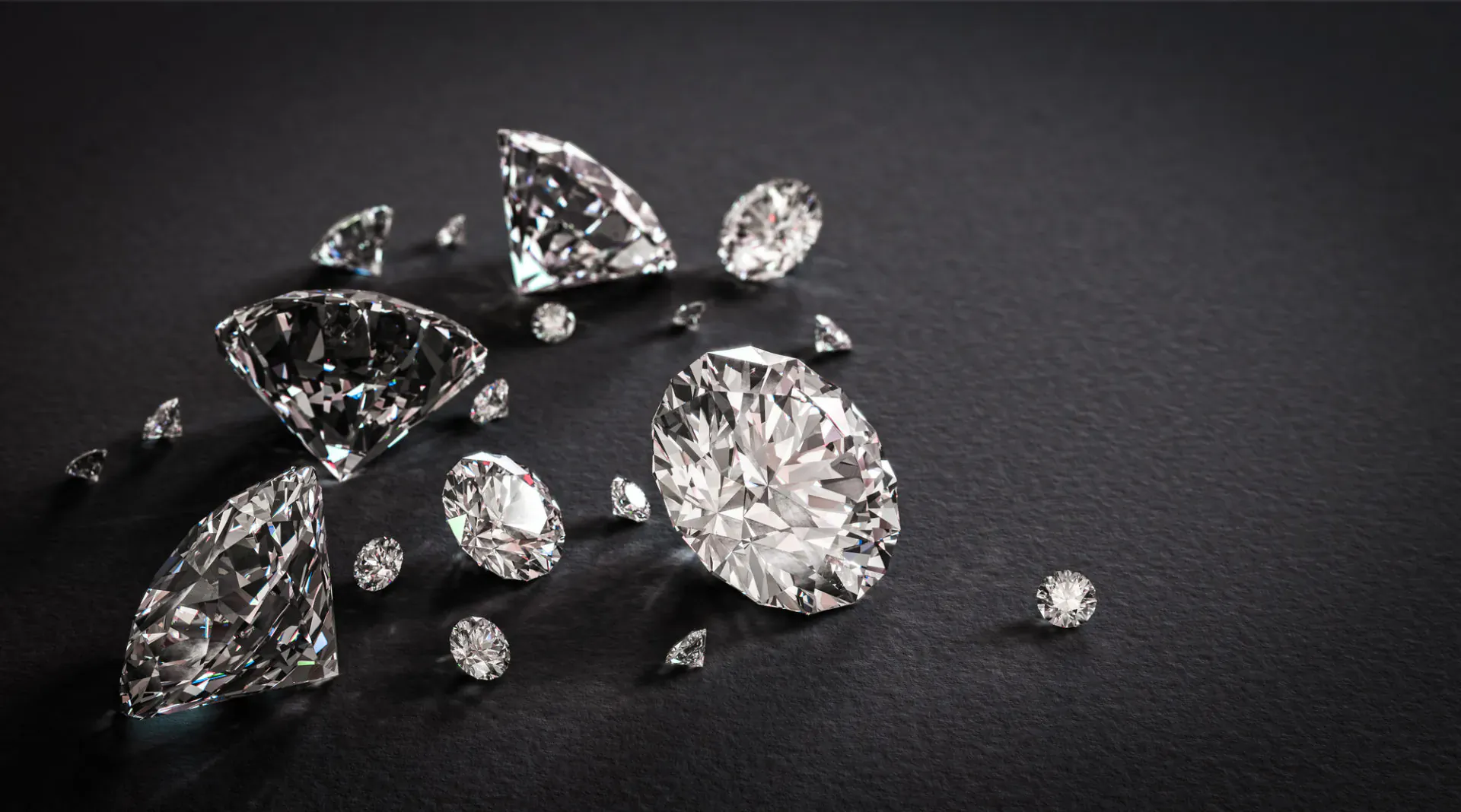 Scatter of sparkling cut diamonds on black background, evoking modern jewelry elegance