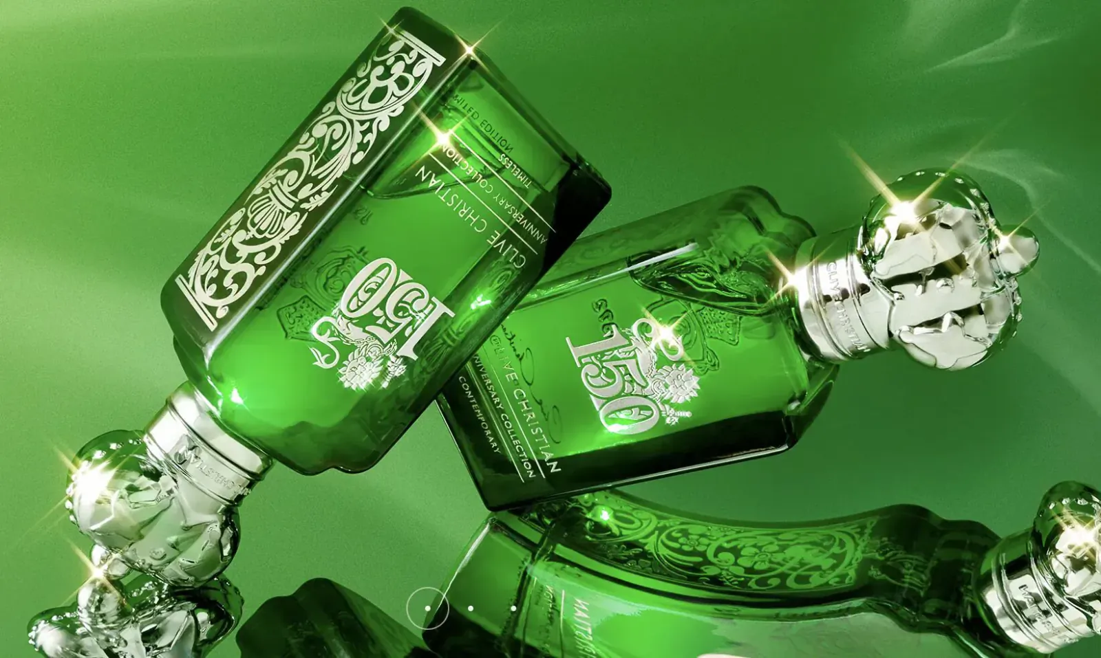 Two ornate green Clive Christian 1872 perfume bottles with crowns, elegantly overlapping on green background.