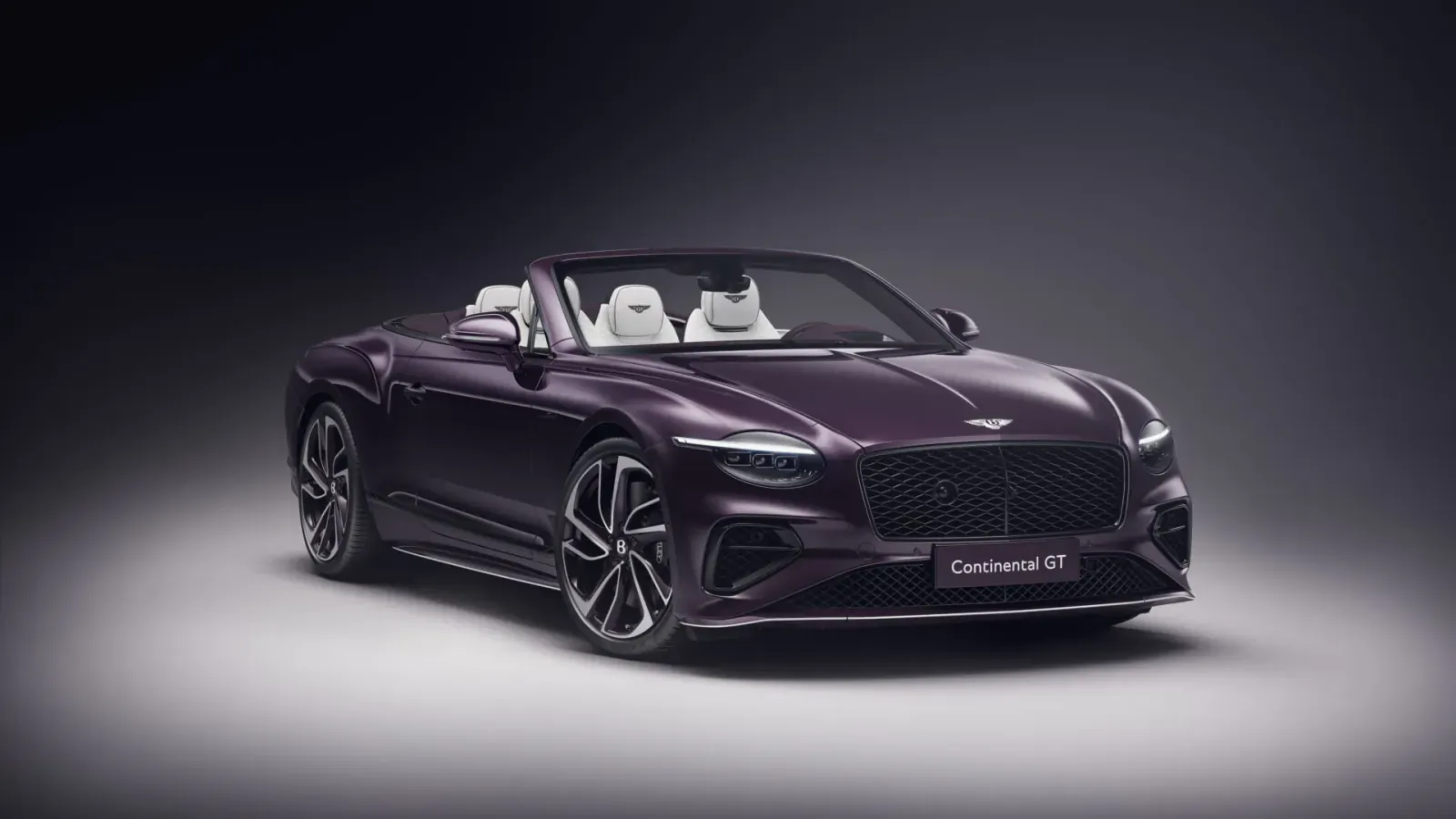 Purple Bentley Continental GTC Speed convertible with white seats, front view on dark background